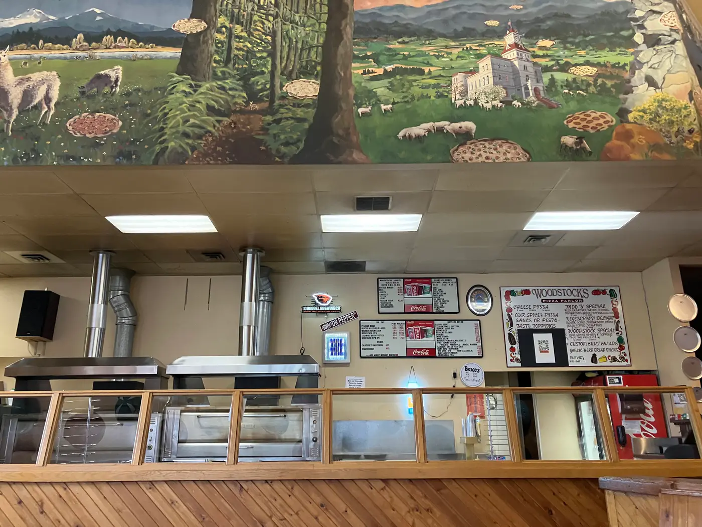 The Woodstock's counter and kitchen under the mural