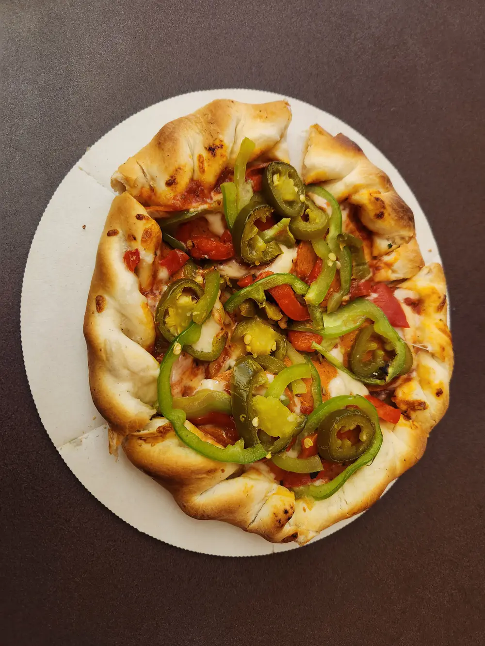A Woodstock's pizza with jalapeños and green peppers